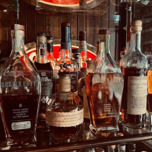 An image of harry’s Country Club’s whiskey bar with whiskeys displayed on the shelves
