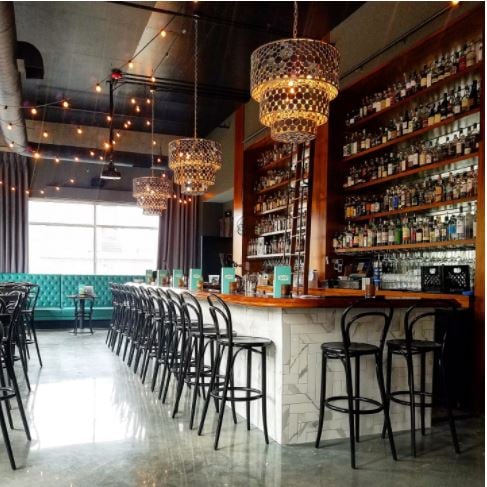 An image of Julep KC’s whiskey bar with the hanging lights turned on.