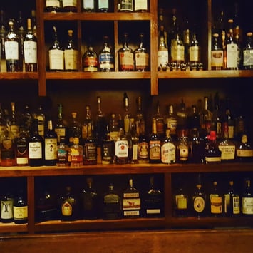 monkey’s paw’s bar where each shelf is full of bottles of drinks