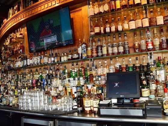 whiskey bar with a game playing on tv